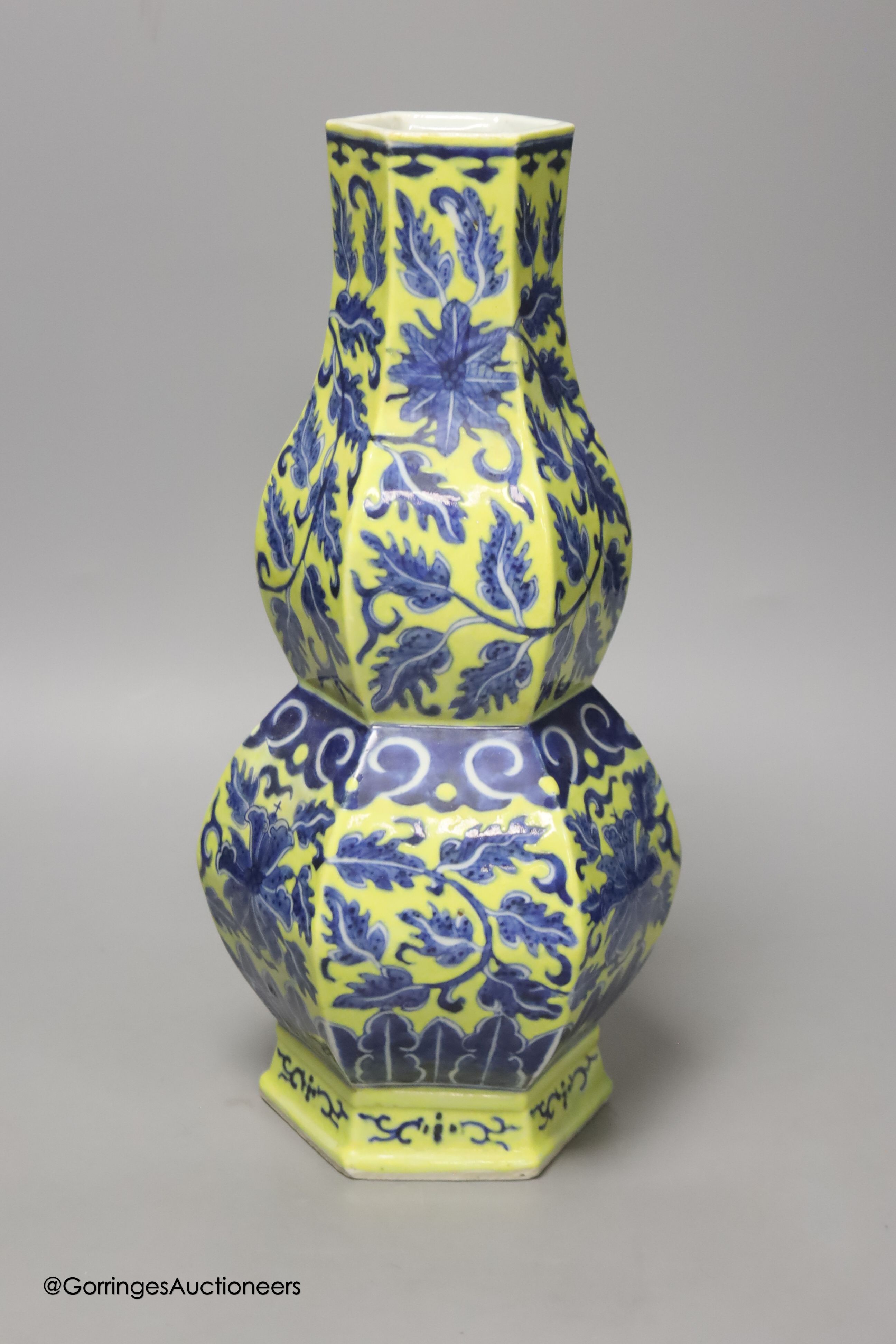 A Chinese underglaze blue yellow ground hexagonal vase, early 20th century, some restoration 35cm